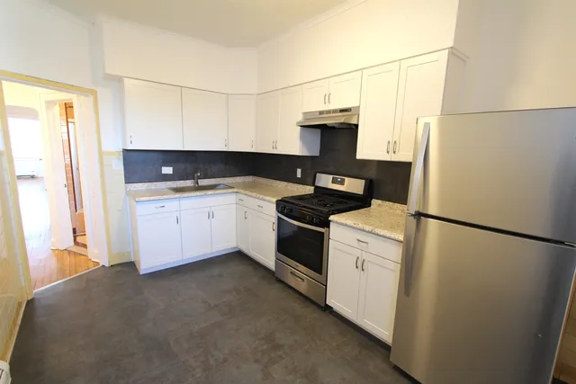 a kitchen with a sink a stove and refrigerator