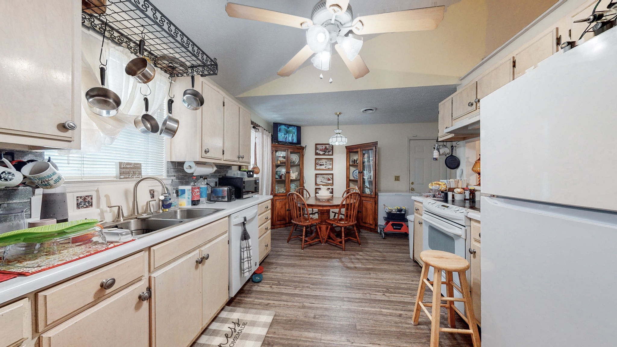 844 Trailside Circle Antioch, TN 37013 - Photo 9 of 27 a kitchen with stainless steel appliances granite countertop a refrigerator a sink dishwasher a dining table and chairs with wooden floor