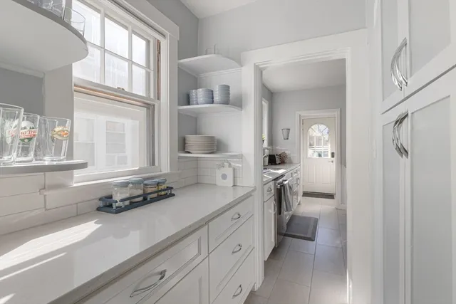 a kitchen with stainless steel appliances a sink stove and refrigerator