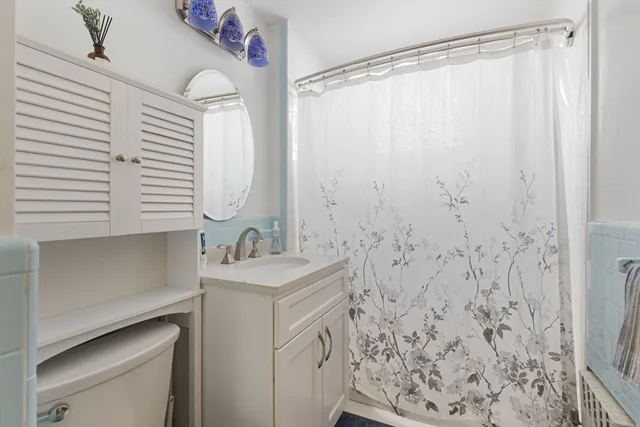 a bathroom with a sink a mirror and a shower curtain