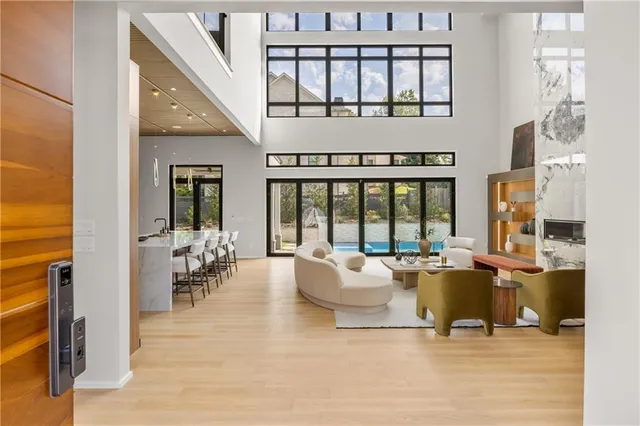 a living room with furniture and large windows