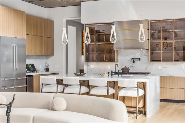 a dining room with furniture a rug a potted plant and a chandelier