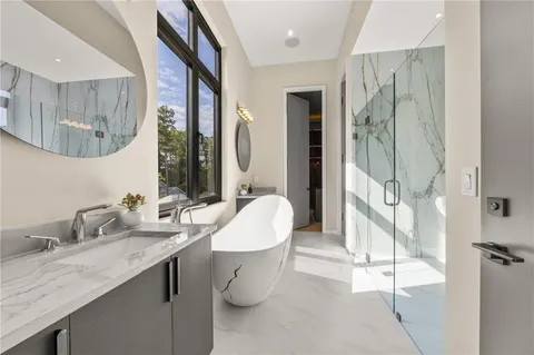 a living room with furniture a large window and a flat screen tv