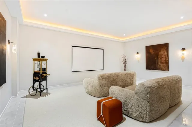 a living room with furniture and large windows