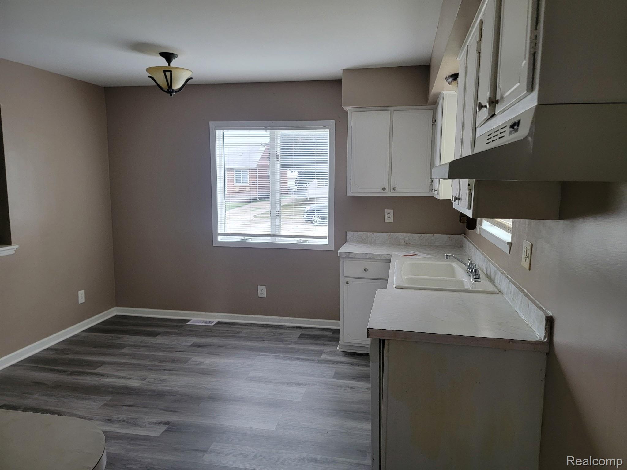 21828 Rausch Avenue Eastpointe, MI 48021 - Photo 5 of 15 White cabinetry with upper and lower storage, dual basin sink, and laminate countertops