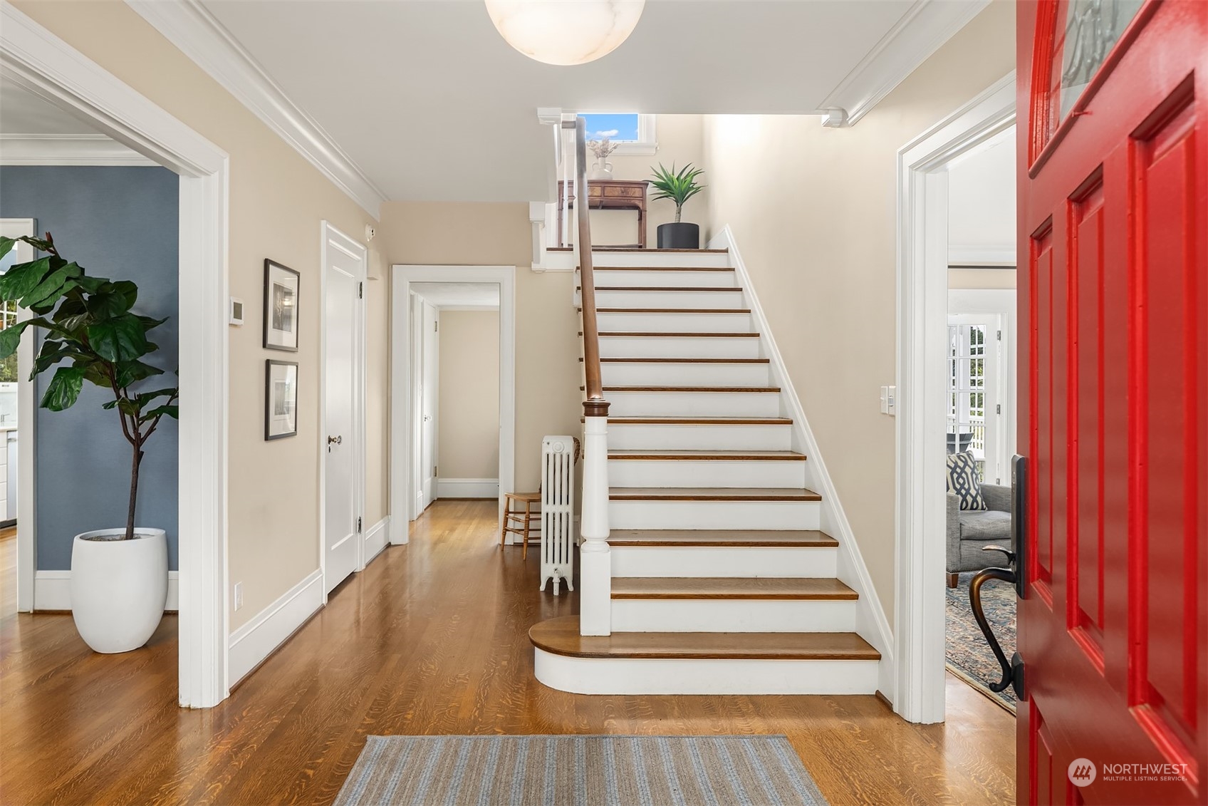 2230 33rd Avenue South Seattle, WA 98144 - Photo 4 of 39 a view of a hallway with wooden floor and staircase
