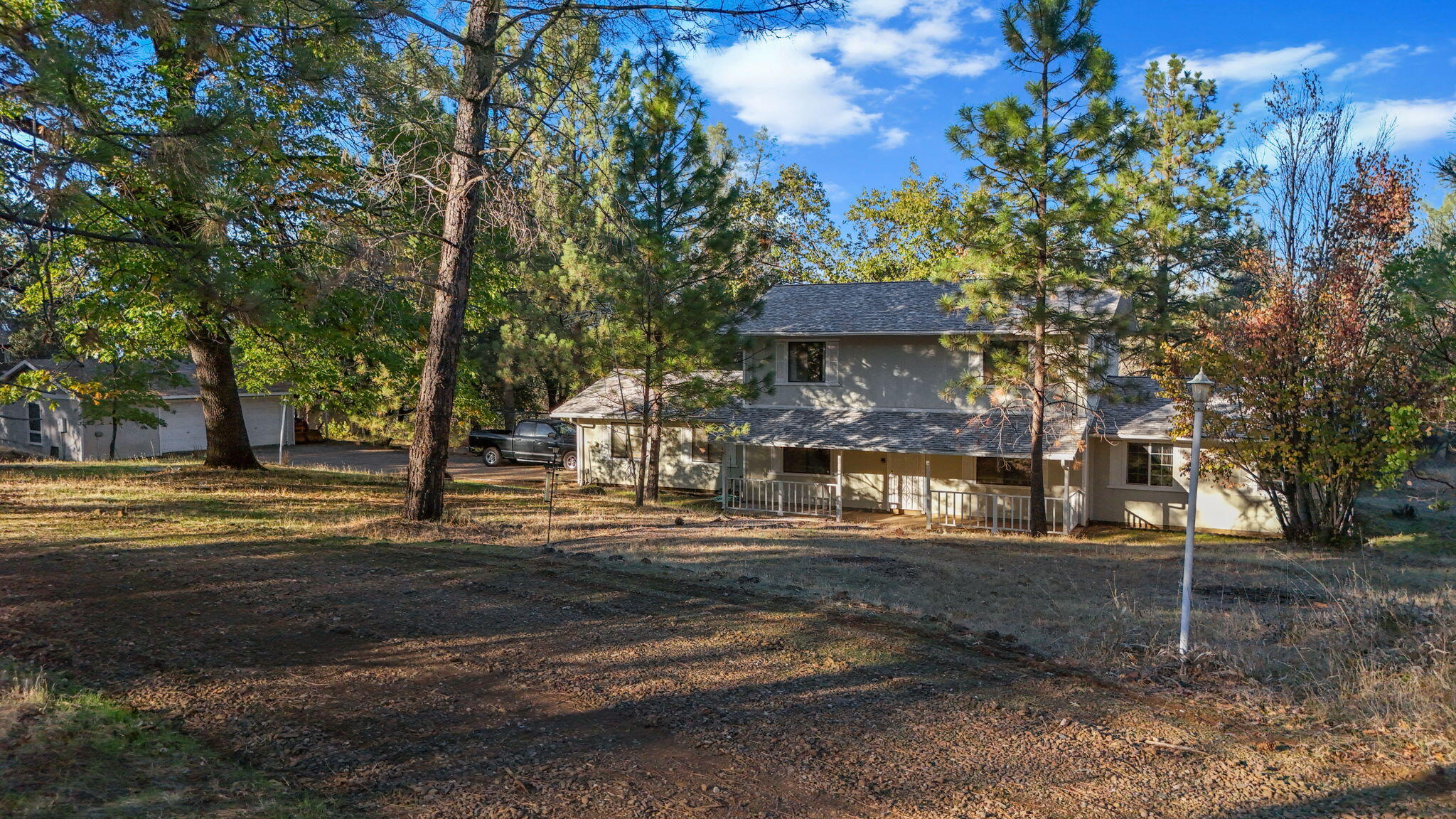 28424 Alpine Way Shingletown, CA 96088 - Photo 1 of 42 a front view of a house with a garden