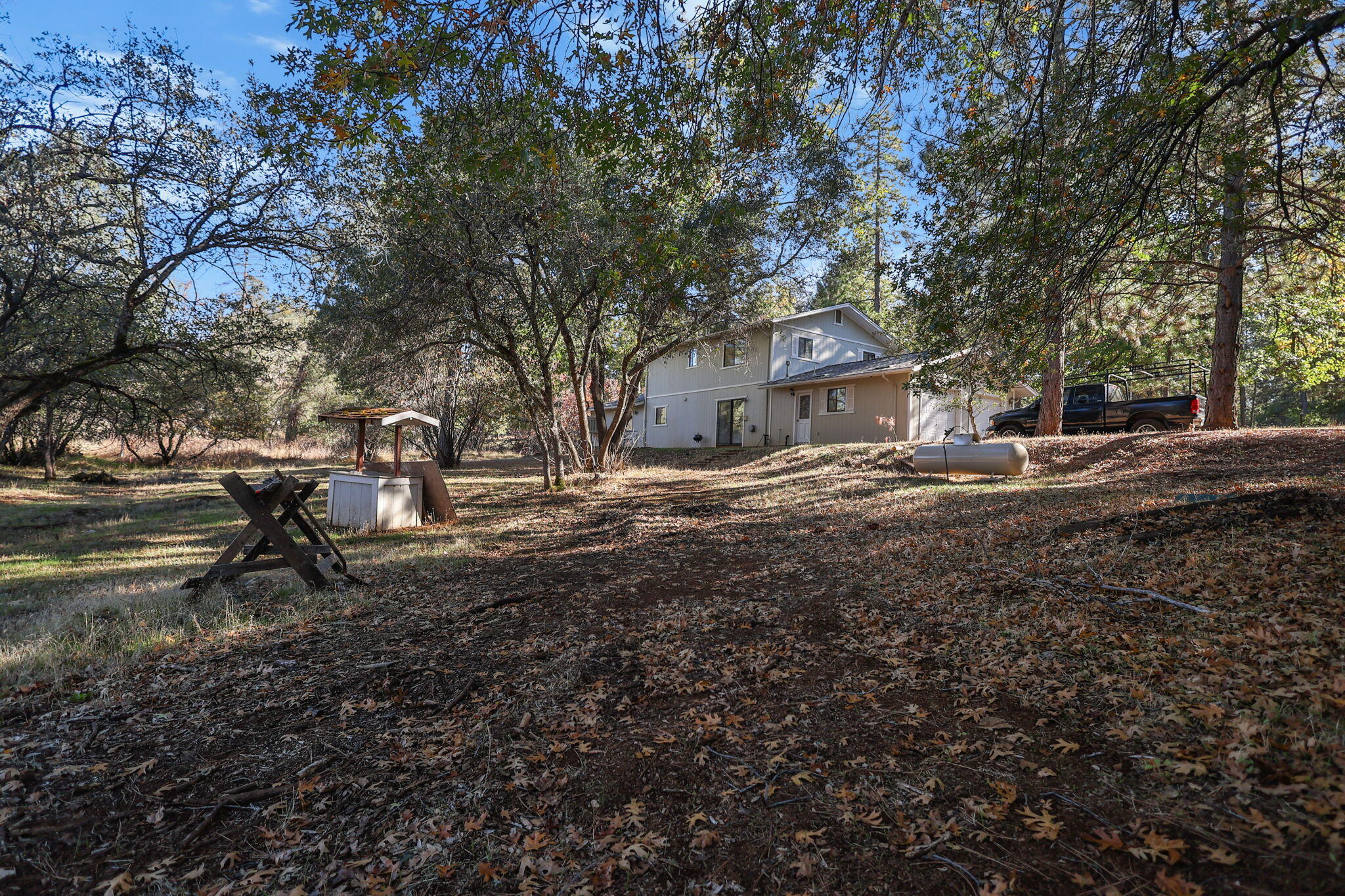 28424 Alpine Way Shingletown, CA 96088 - Photo 37 of 42 a backyard of a house with barbeque oven table and chairs