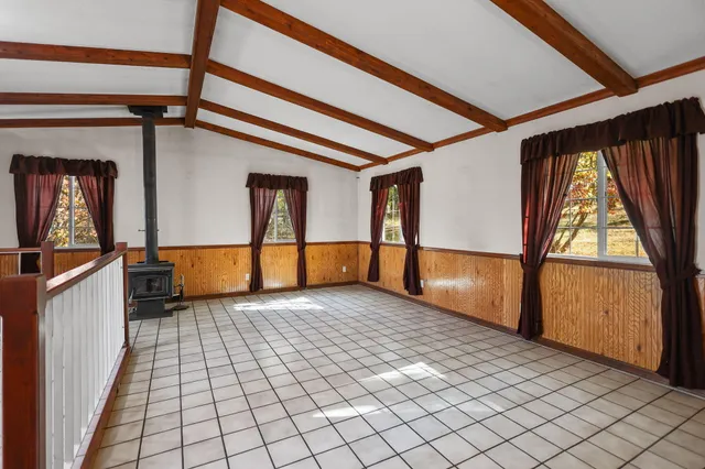 a view of staircase with railing and a chandelier