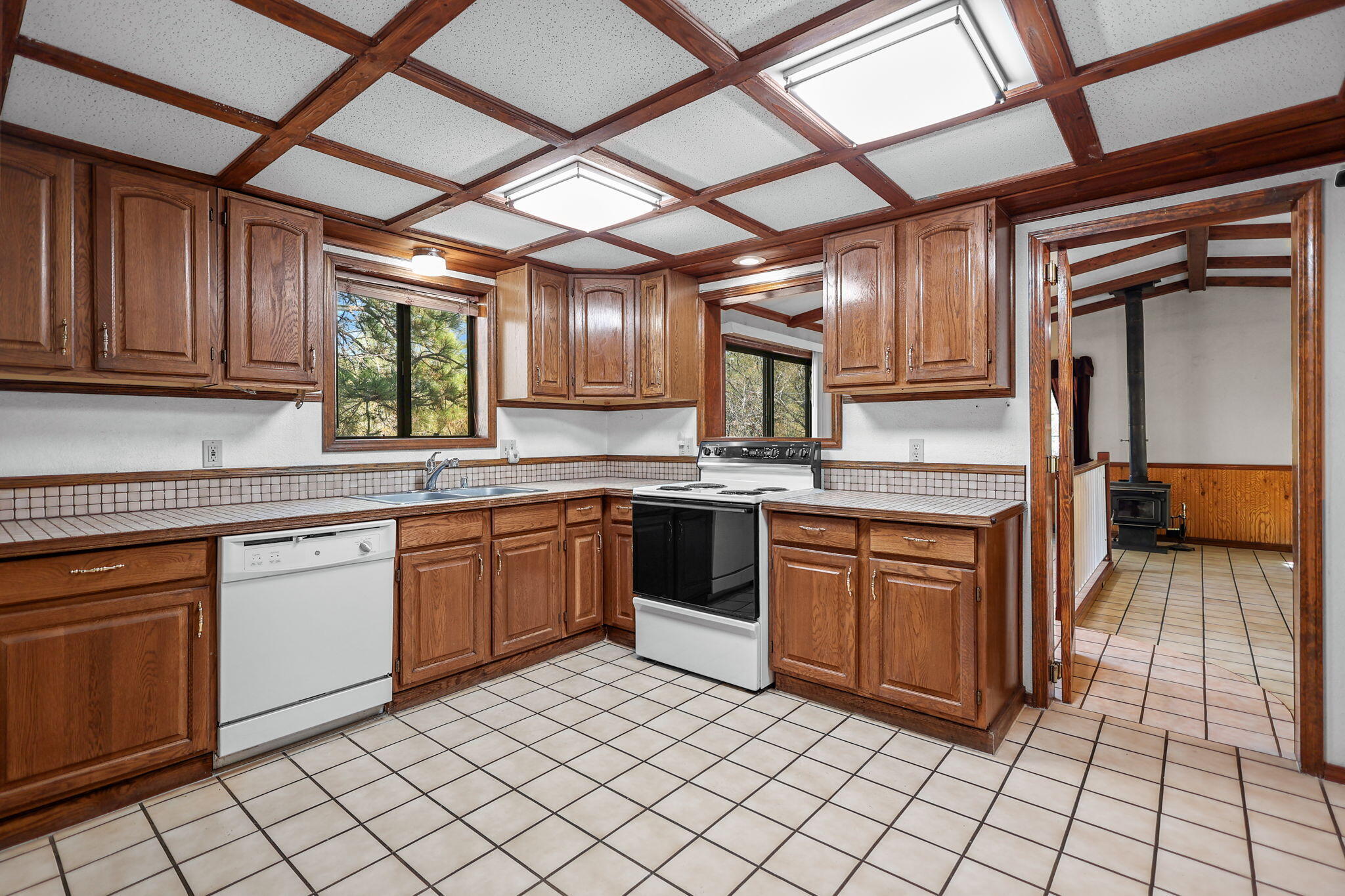 28424 Alpine Way Shingletown, CA 96088 - Photo 9 of 42 a kitchen with stainless steel appliances granite countertop a stove a sink and a microwave