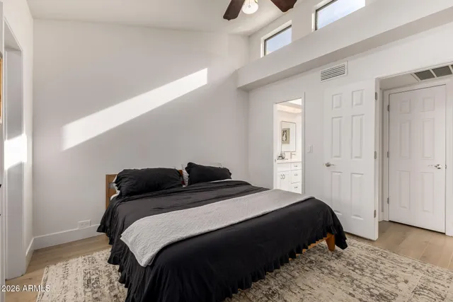 a bedroom with a bed and wooden floor