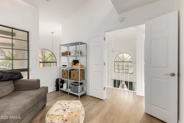 a living room with furniture a window and gym equipment