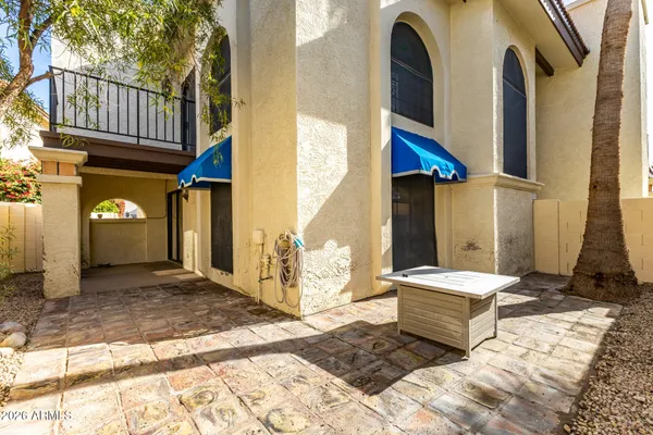 a view of a house with large windows and couches