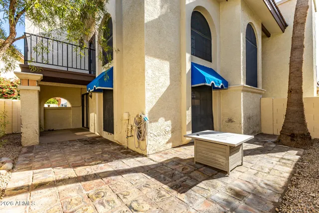 a view of a house with large windows and couches