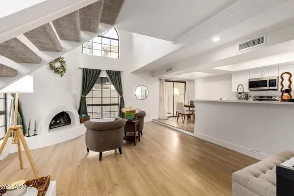 a living room with furniture a dining table and wooden floor