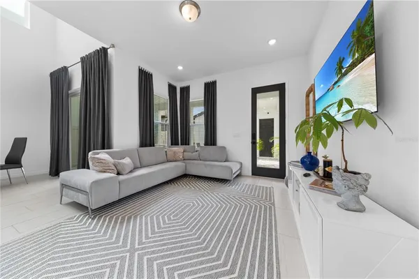a living room with furniture and large windows