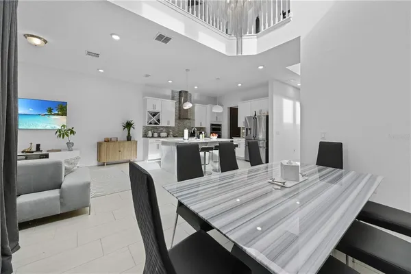 a view of a dining room with furniture and a kitchen