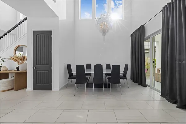 a dining room with furniture and a chandelier