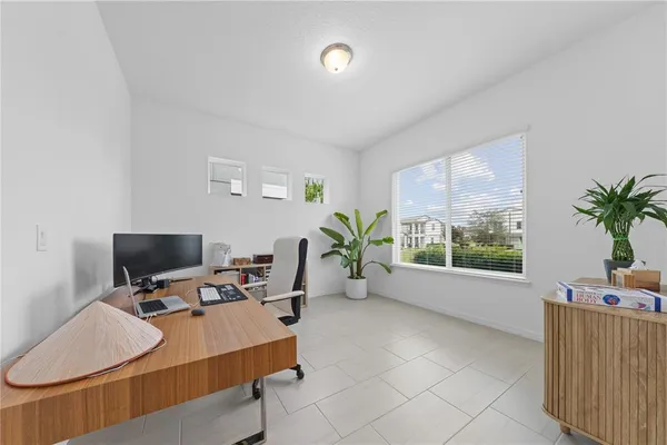 a view of a workspace with furniture and a window