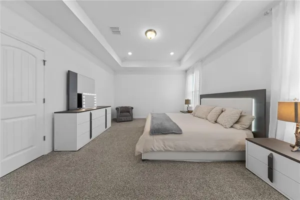 a spacious bedroom with a bed and a couch