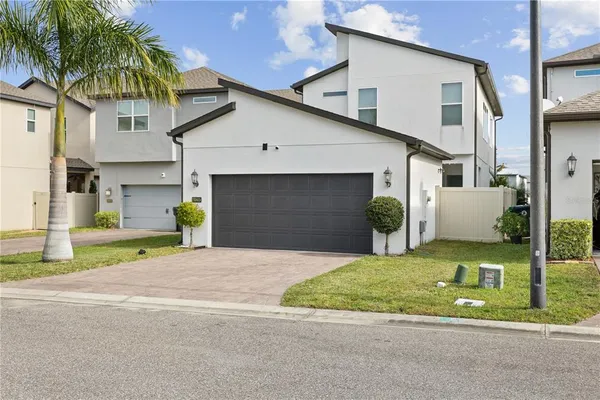 a front view of a house with a yard and garage