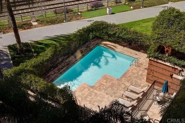 a view of a swimming pool with a yard