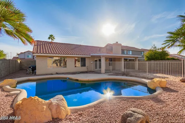 a front view of house with swimming pool and patio