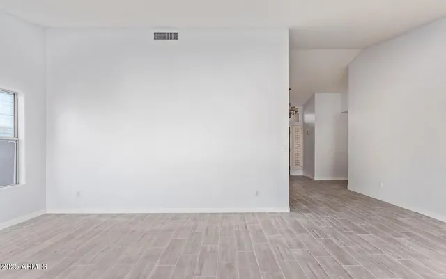 an empty room with wooden floor