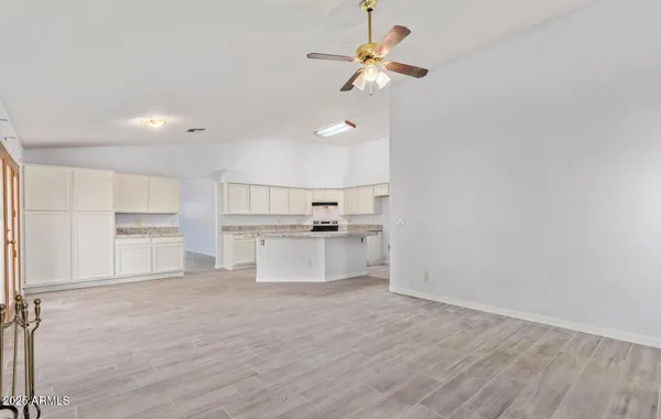 a view of a kitchen with wooden floor and a sink