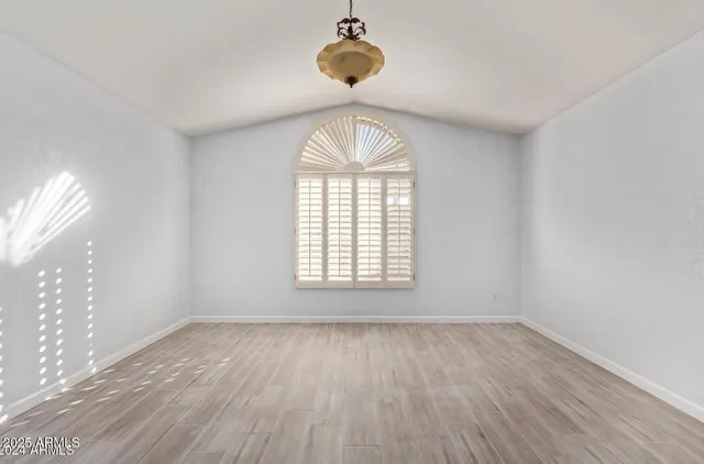 a bathroom with a tub a sink double vanity and mirror
