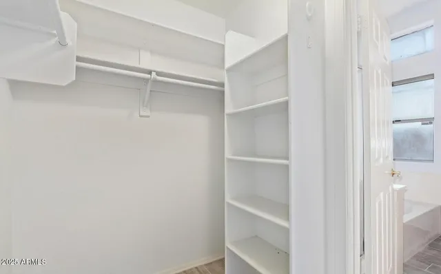 a view of a small space with wooden floor and a window