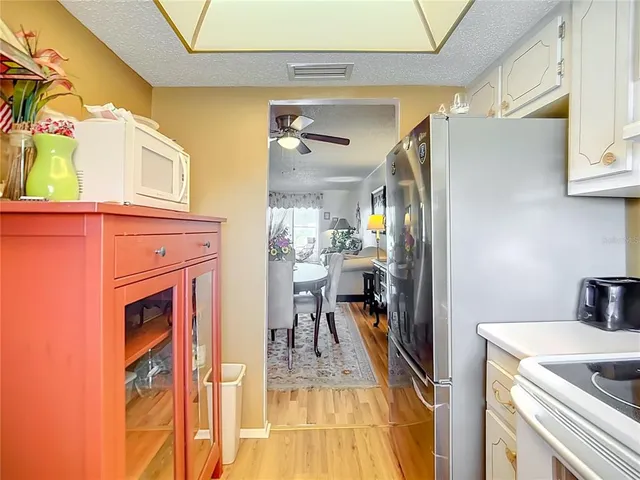 a kitchen with a refrigerator and a stove