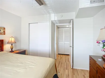 a bedroom with a bed and a lamp