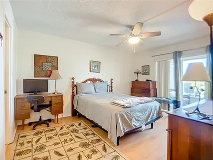 a bedroom with a bed and a desk