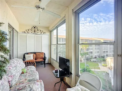 a balcony with furniture and a potted plant