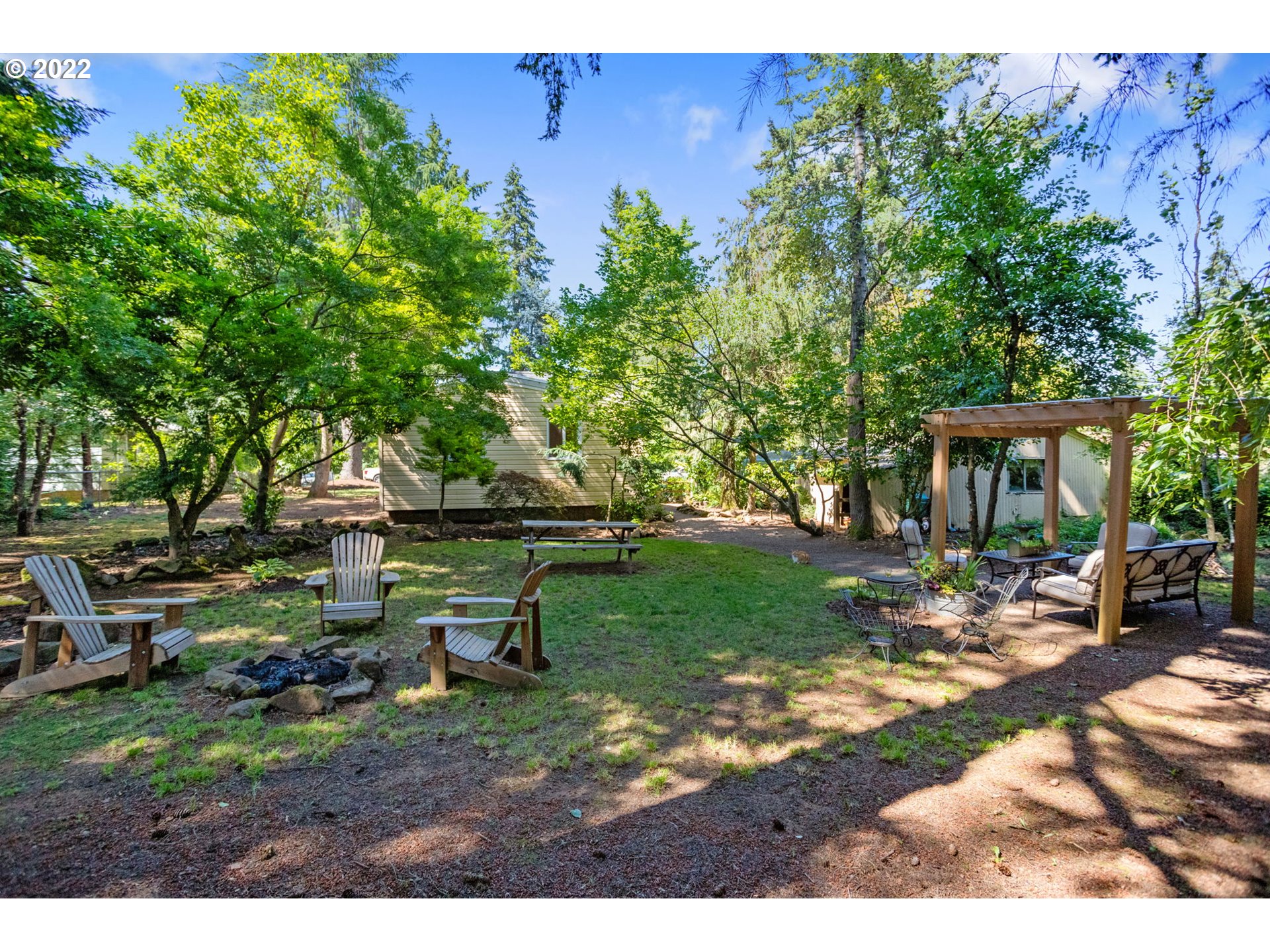 2020 Southeast Waldron Road Milwaukie, OR 97222 - Photo 26 of 32 a view of a house with backyard sitting area and garden