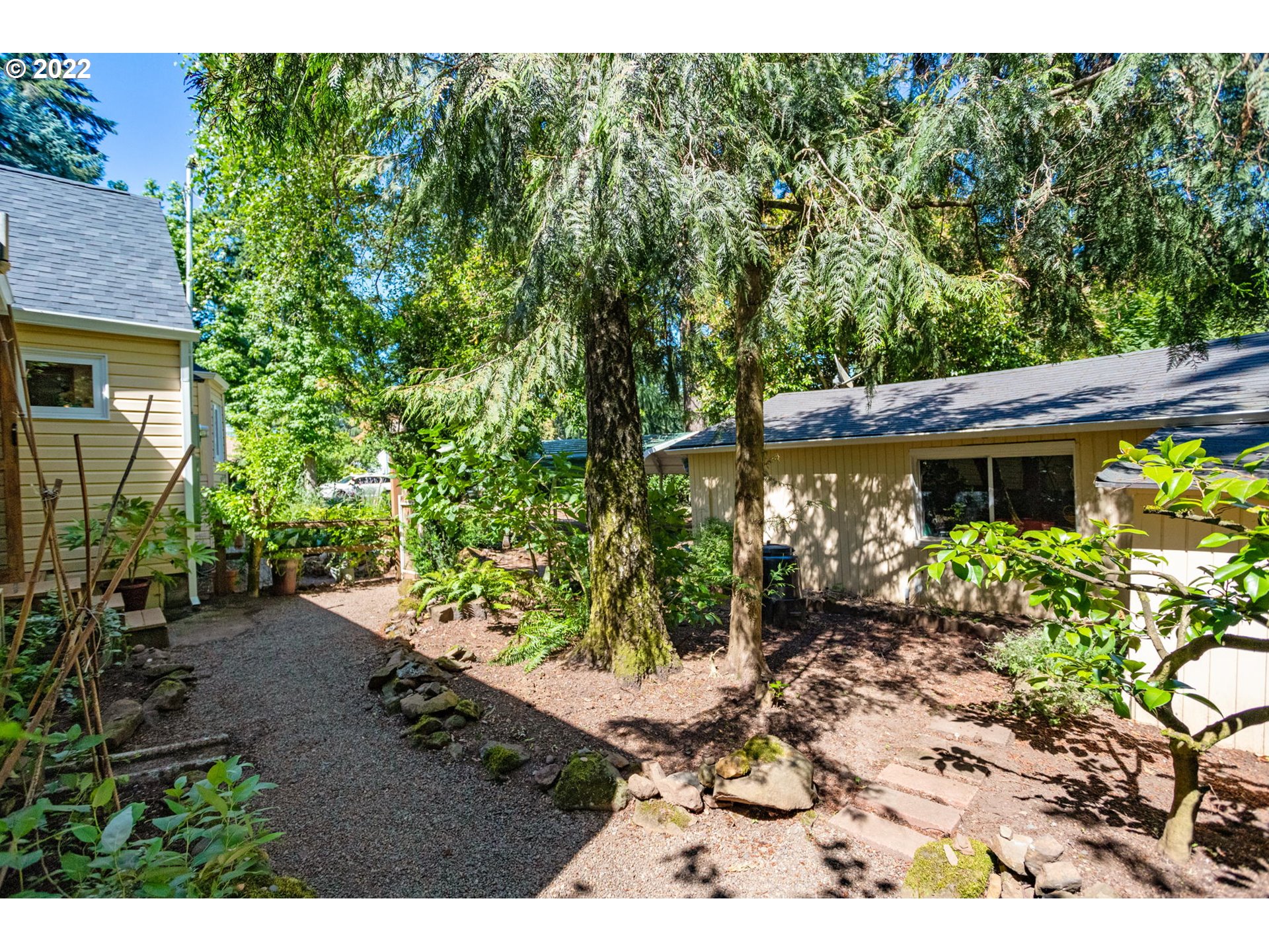 2020 Southeast Waldron Road Milwaukie, OR 97222 - Photo 28 of 32 a backyard of a house with a garden and outdoor seating