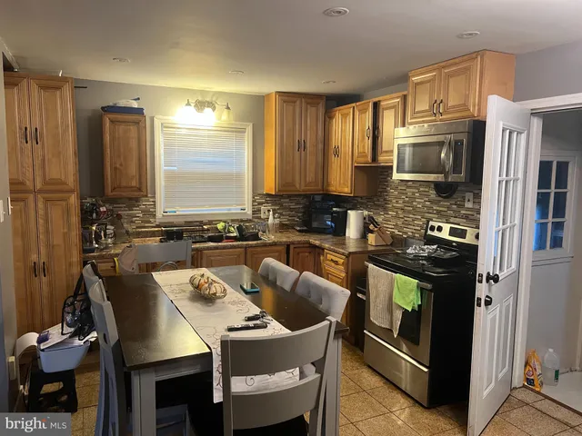 a kitchen with a stove a sink and a refrigerator