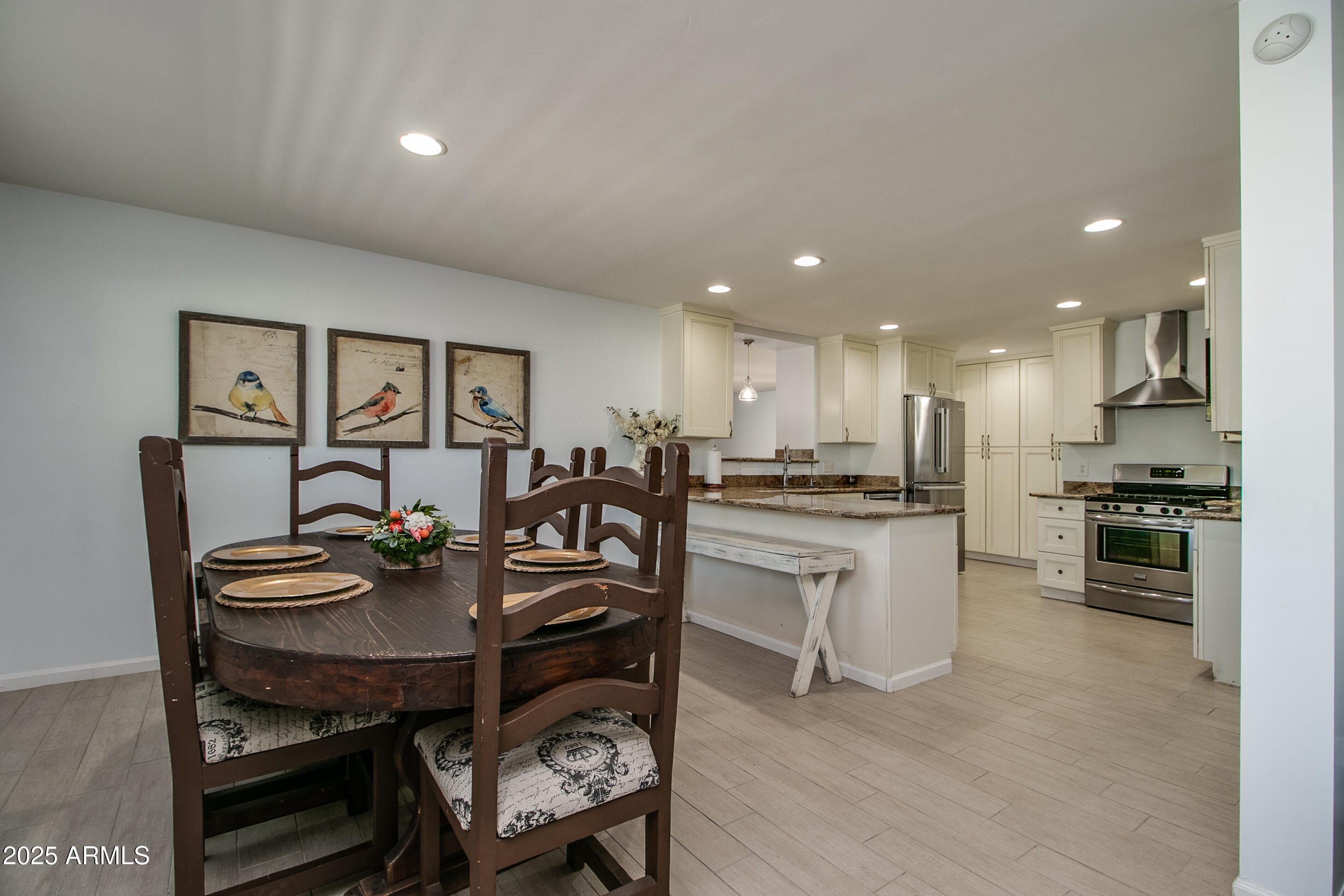 2017 West Edgemont Avenue Phoenix, AZ 85009 - Photo 10 of 53 a open dining room with stainless steel appliances kitchen island granite countertop a stove a sink a dining table and chairs