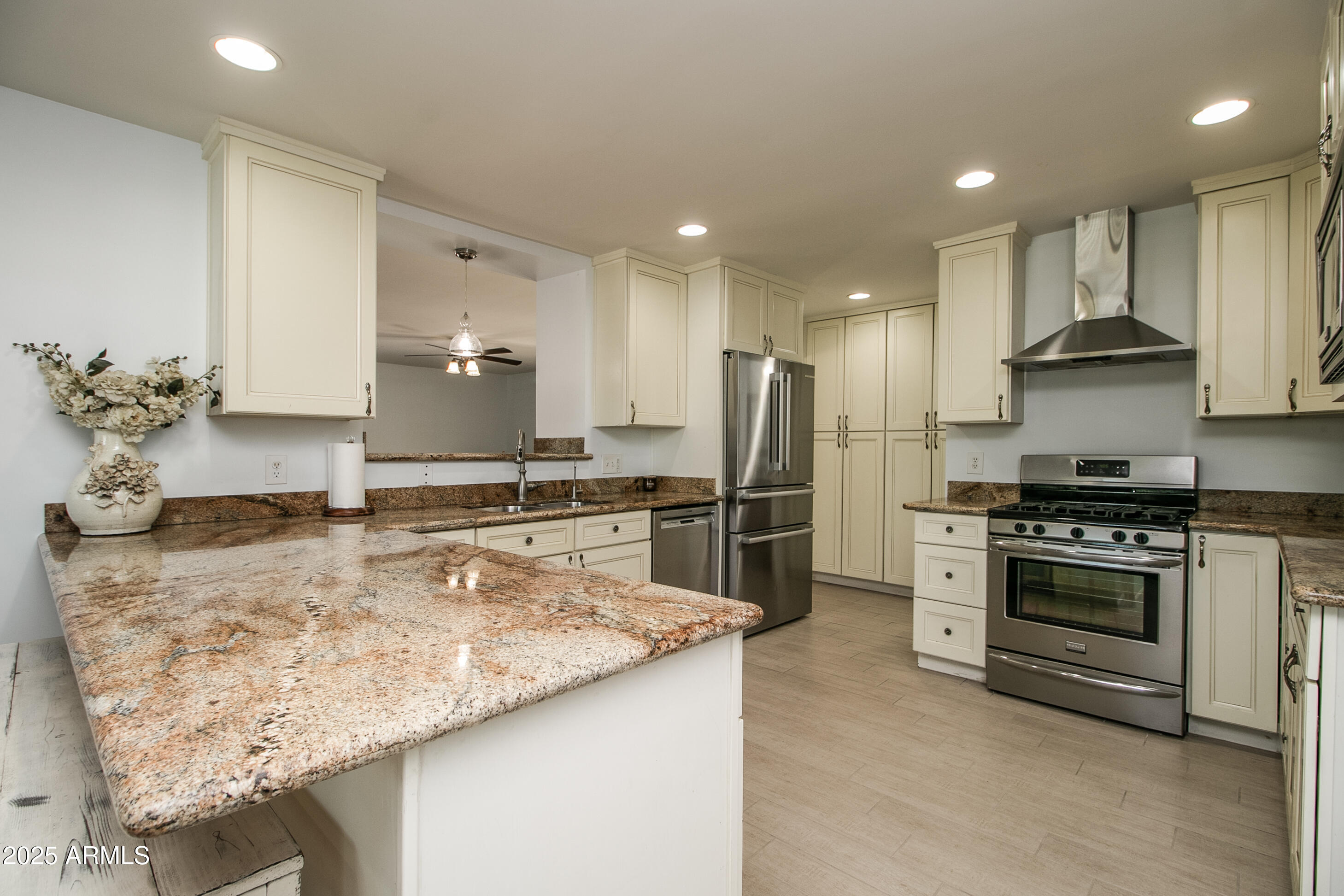 2017 West Edgemont Avenue Phoenix, AZ 85009 - Photo 14 of 53 a kitchen with stainless steel appliances granite countertop a sink stove and refrigerator