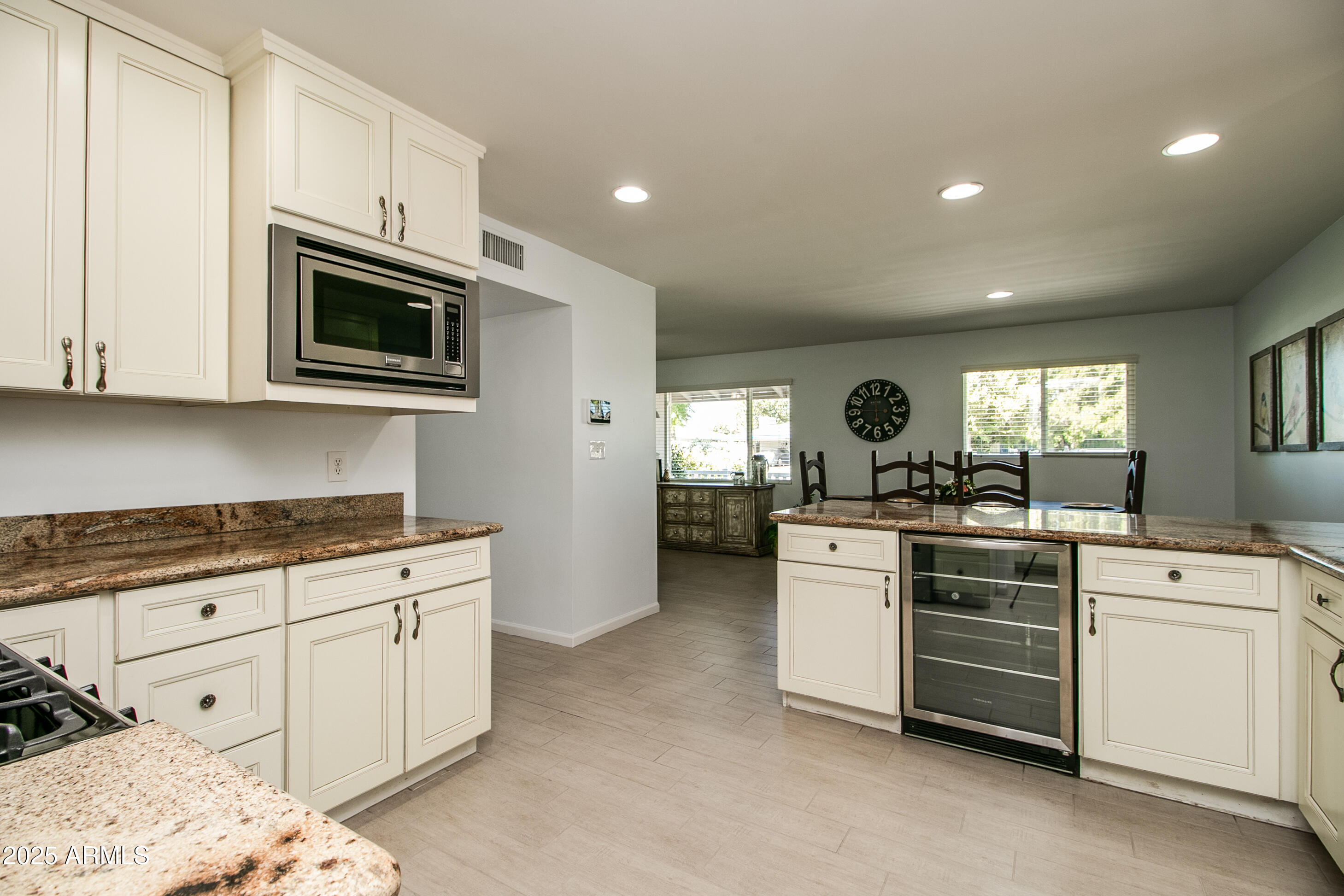 2017 West Edgemont Avenue Phoenix, AZ 85009 - Photo 16 of 53 a kitchen with white cabinets and white appliances