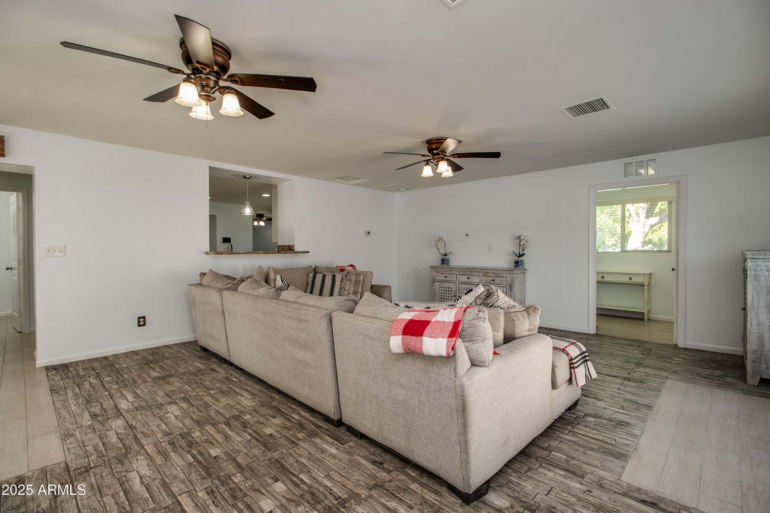 2017 West Edgemont Avenue Phoenix, AZ 85009 - Photo 19 of 53 a living room with furniture and a chandelier