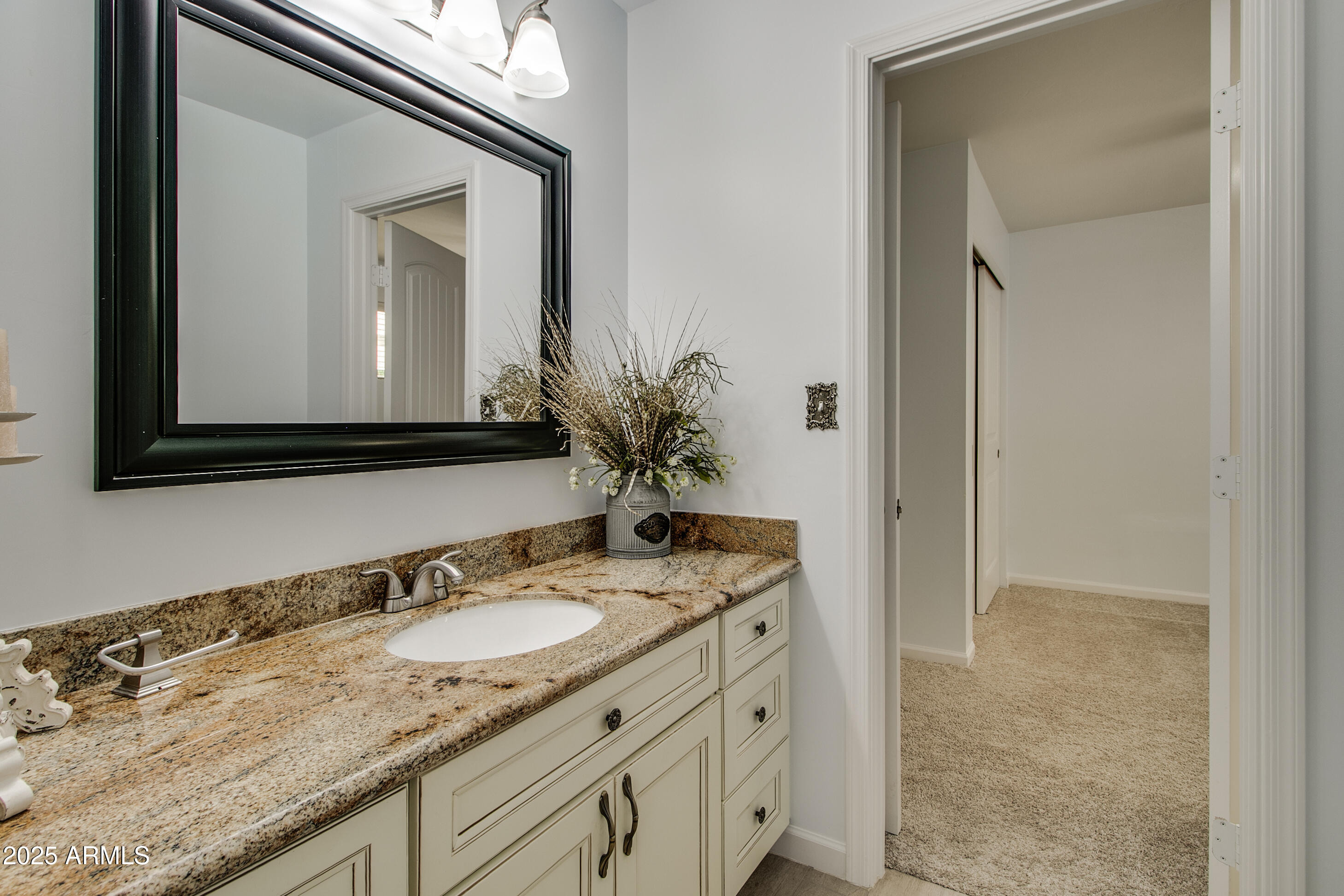 2017 West Edgemont Avenue Phoenix, AZ 85009 - Photo 34 of 53 a bathroom with a granite countertop sink and a mirror