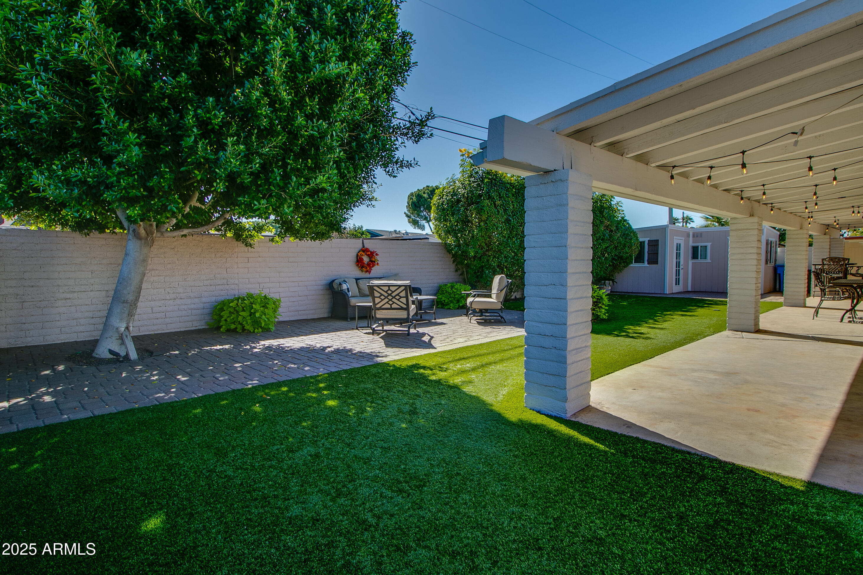 2017 West Edgemont Avenue Phoenix, AZ 85009 - Photo 38 of 53 a view of a patio with table and chairs potted plants and large tree