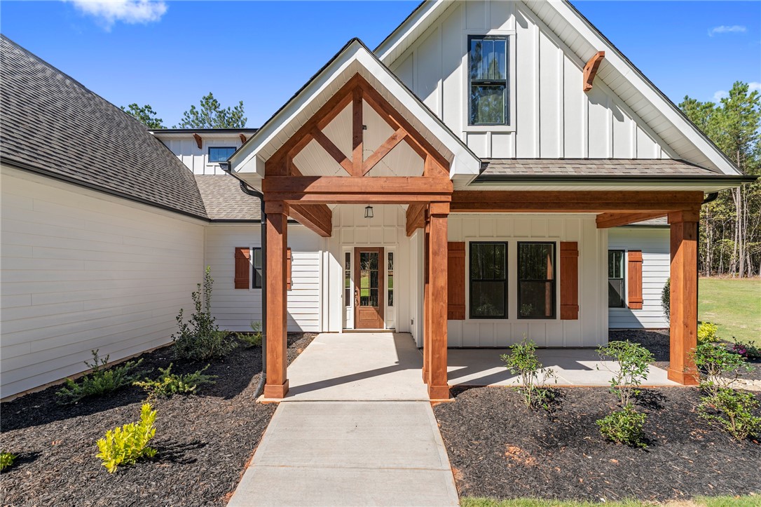 1031 Hill Road Anderson, SC 29621 - Photo 3 of 35 A welcoming front entrance showcases striking wood beam accents against crisp white siding.