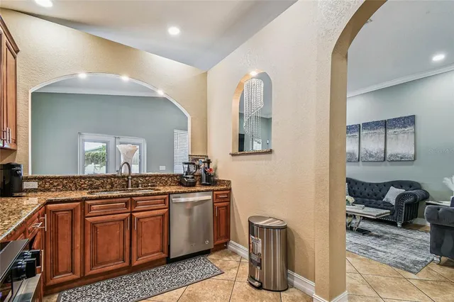 a kitchen with stainless steel appliances granite countertop a stove sink microwave and cabinets