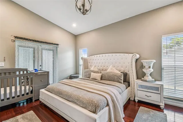 a bedroom with furniture and a flat screen tv