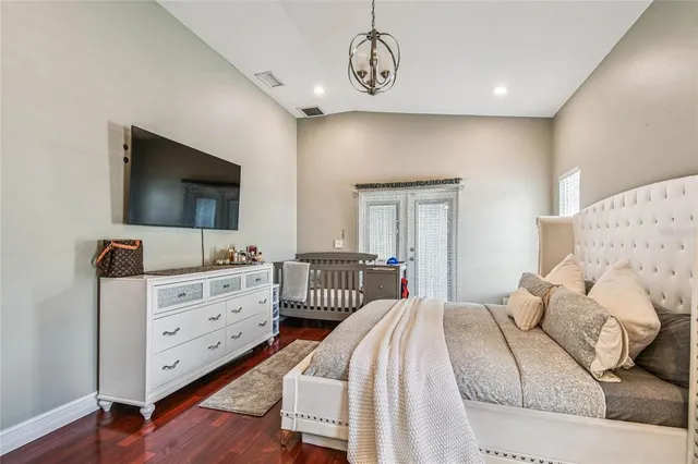 a bedroom with a bed and flat screen tv