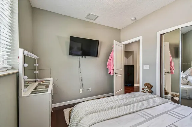 a view of a house with backyard and a tree