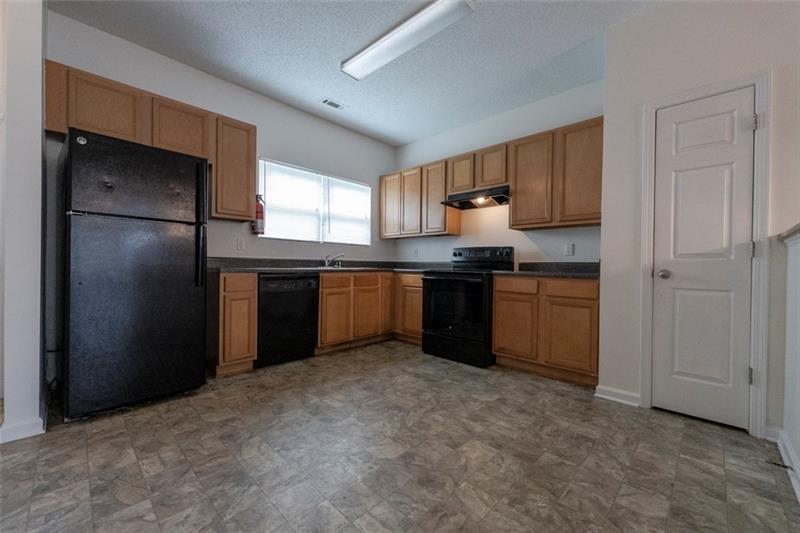 6045 Capitol Knoll Fairburn, GA 30213 - Photo 13 of 37 a kitchen with stainless steel appliances granite countertop a refrigerator and a sink